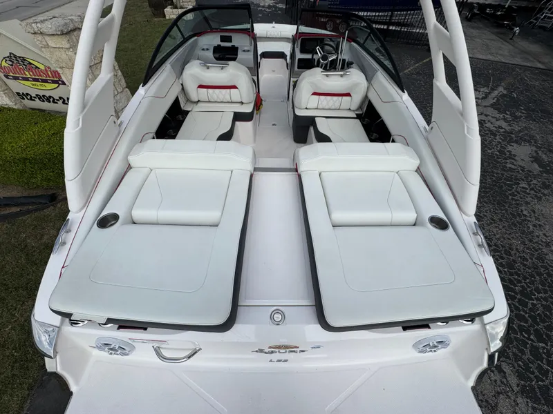 Slide: The Image of 2020 Regal LS2 Surf boat with white seating and sleek design. - 9