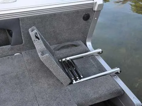 Slide: The Image of 2026 Lund 2075 Tyee boat with foldable ladder on carpeted deck near water. - 13