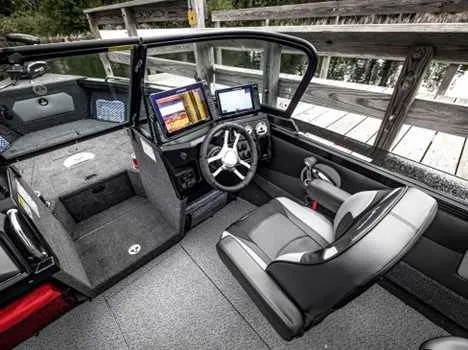 Slide: The Image of 2026 Lund 2075 Tyee boat interior with modern dashboard and seating. - 2