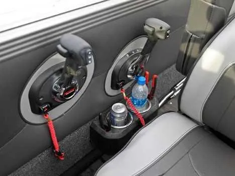 Slide: The Image of Interior of 2026 Lund 2075 Tyee boat with cup holders and control levers. - 3