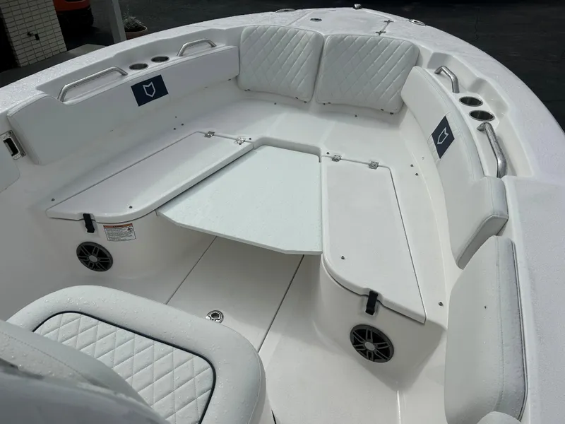 Slide: The Image of 2025 Sea Fox 248 Commander boat interior with white cushioned seating and table. - 7