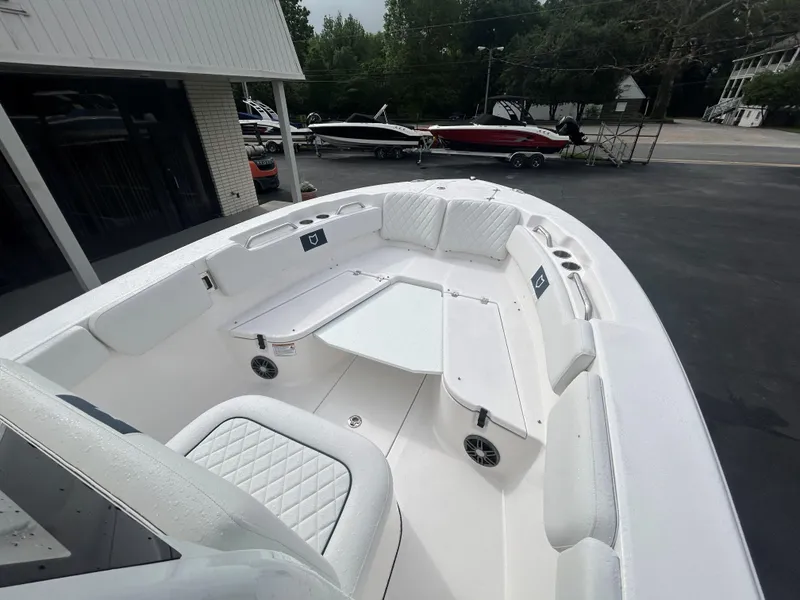 Slide: The Image of 2025 Sea Fox 248 Commander boat with spacious seating and sleek design in a marina setting. - 9