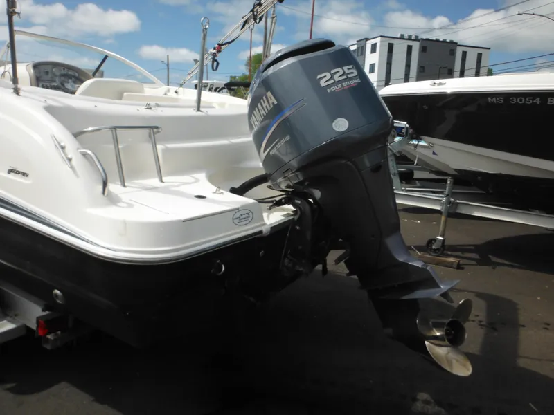 Slide: The Image of 2007 Hurricane SD 237 boat with Yamaha 225 outboard motor, docked outdoors. - 10
