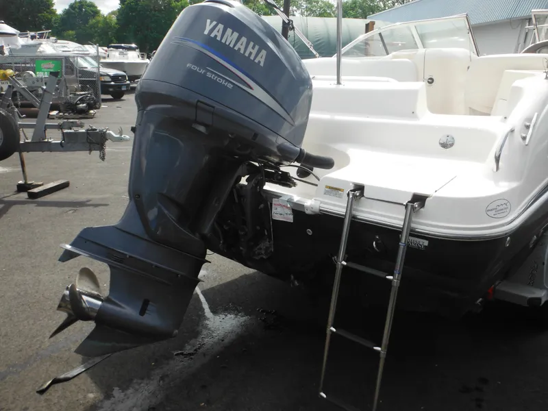 Slide: The Image of 2007 Hurricane SD 237 boat with Yamaha outboard motor and ladder, parked in marina. - 11