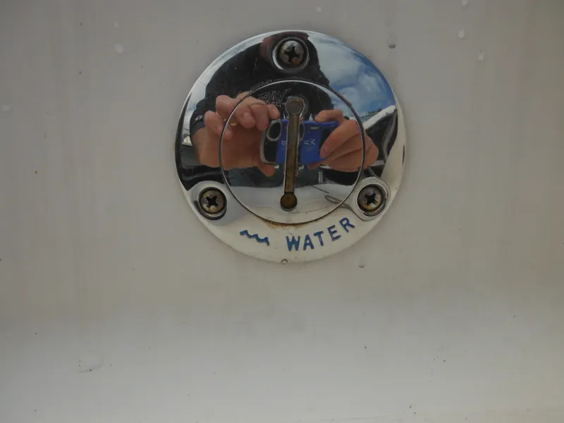 Slide: The Image of Water inlet on 2007 Hurricane SD 237 boat, with reflection of person taking photo. - 16