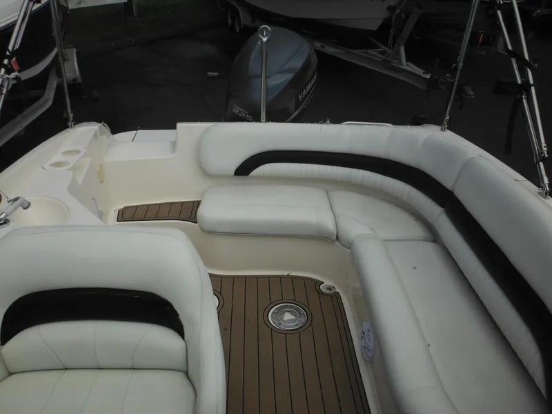 Slide: The Image of 2007 Hurricane SD 237 boat interior with white seating and wood flooring. - 17