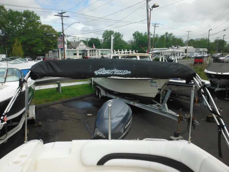 Slide: The Image of 2007 Hurricane SD 237 boat with canopy in a marina parking lot. - 18