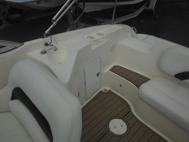 Slide: The Image of Interior of 2007 Hurricane SD 237 boat with white seating and wood-style flooring. - 20