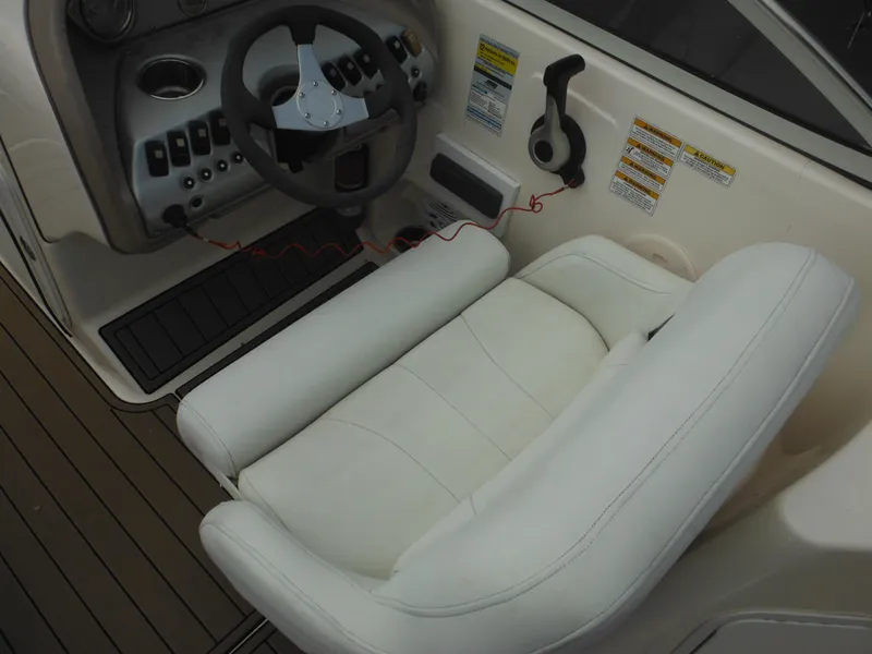 Slide: The Image of 2007 Hurricane SD 237 boat cockpit with steering wheel and white captain's seat. - 22