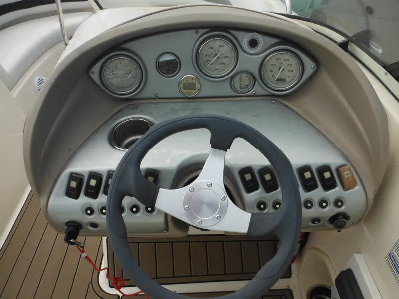 Slide: The Image of Steering console of 2007 Hurricane SD 237 boat with gauges and controls. - 23