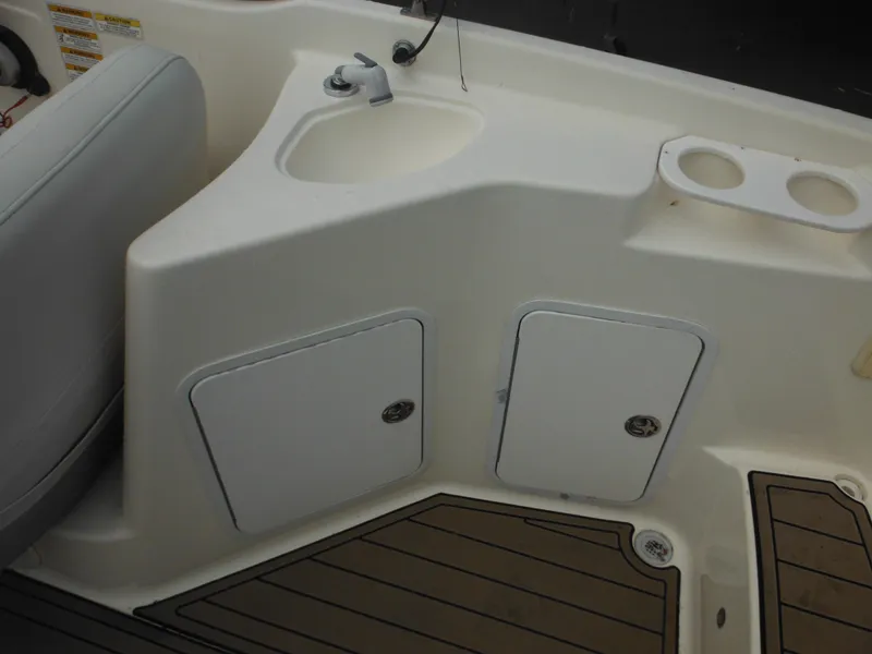 Slide: The Image of 2007 Hurricane SD 237 boat interior with sink, storage, and cup holders. - 24