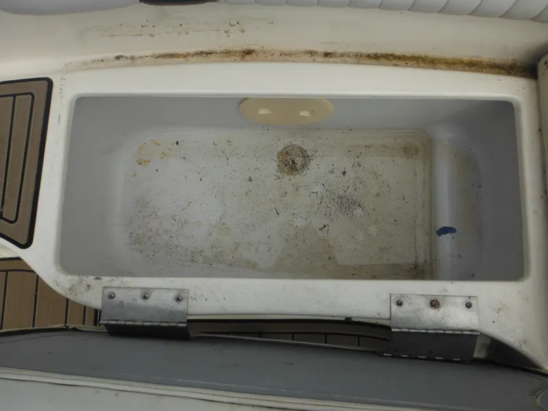 Slide: The Image of 2007 Hurricane SD 237 boat storage compartment with visible wear and dirt. - 30