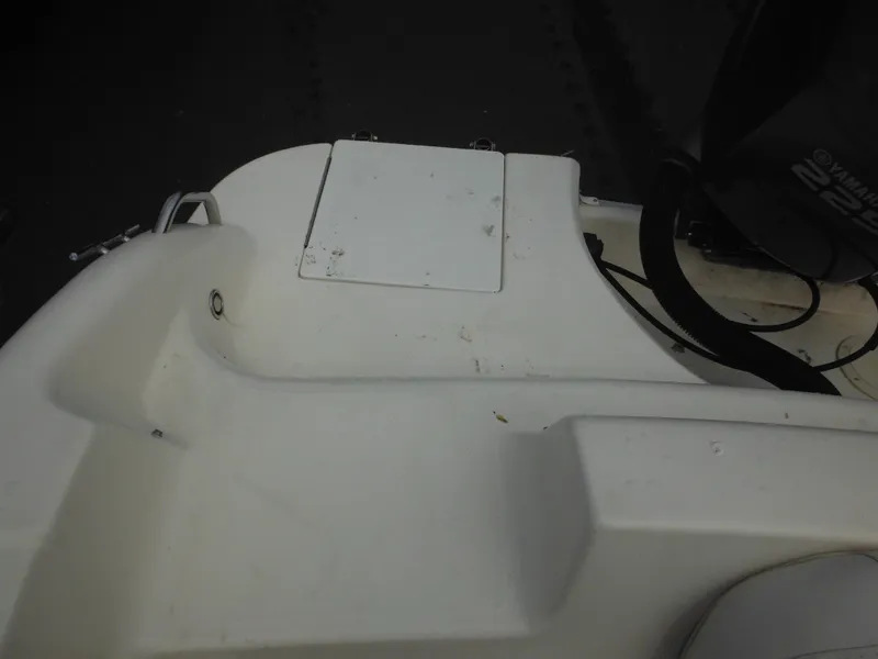 Slide: The Image of 2007 Hurricane SD 237 boat deck with storage compartment and motor. - 31