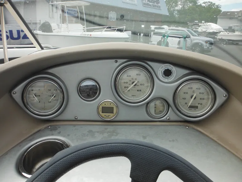 Slide: The Image of Dashboard of a 2007 Hurricane SD 237 boat with gauges and steering wheel. - 35