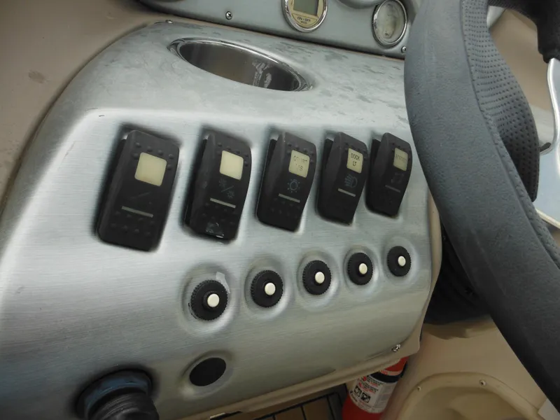 Slide: The Image of Control panel of a 2007 Hurricane SD 237 boat with switches and dials. - 37