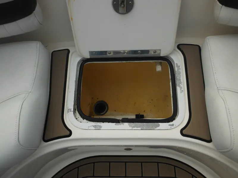 Slide: The Image of Open storage compartment on a 2007 Hurricane SD 237 boat, featuring white and brown seating. - 42