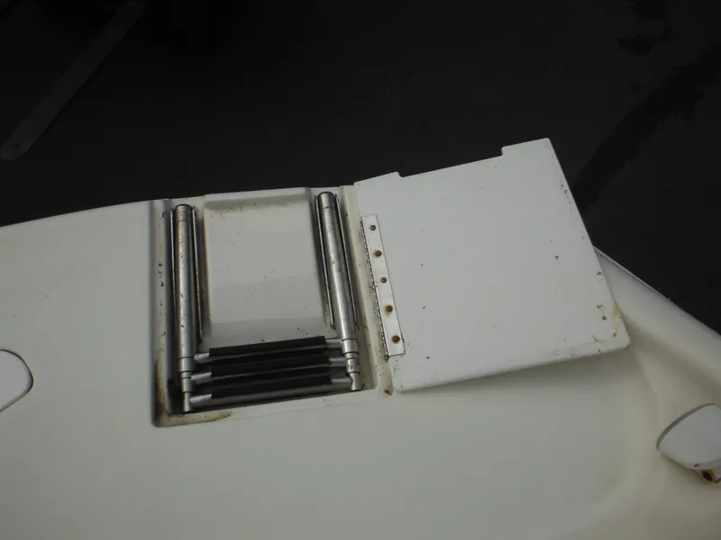 Slide: The Image of 2007 Hurricane SD 237 boat ladder with white cover, partially open. - 45