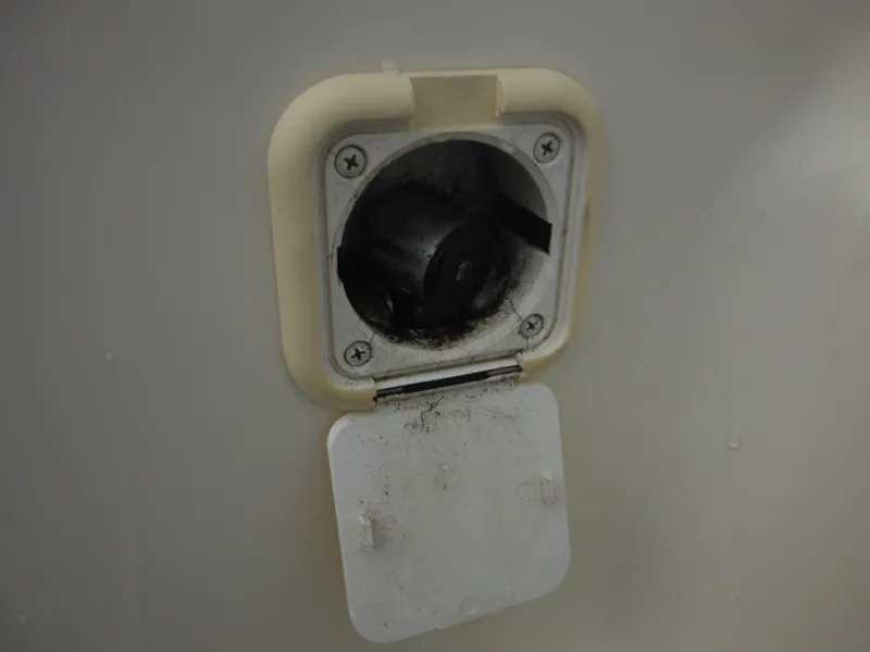 Slide: The Image of Fuel cap compartment of a 2007 Hurricane SD 237 boat, showing wear and dirt. - 49