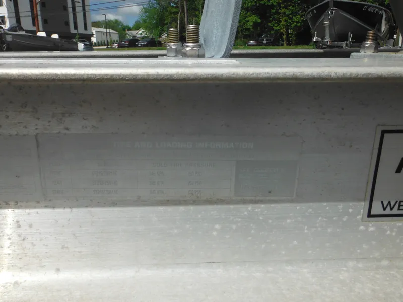 Slide: The Image of 2007 Hurricane SD 237 boat detail with metal surface and label in outdoor setting. - 6