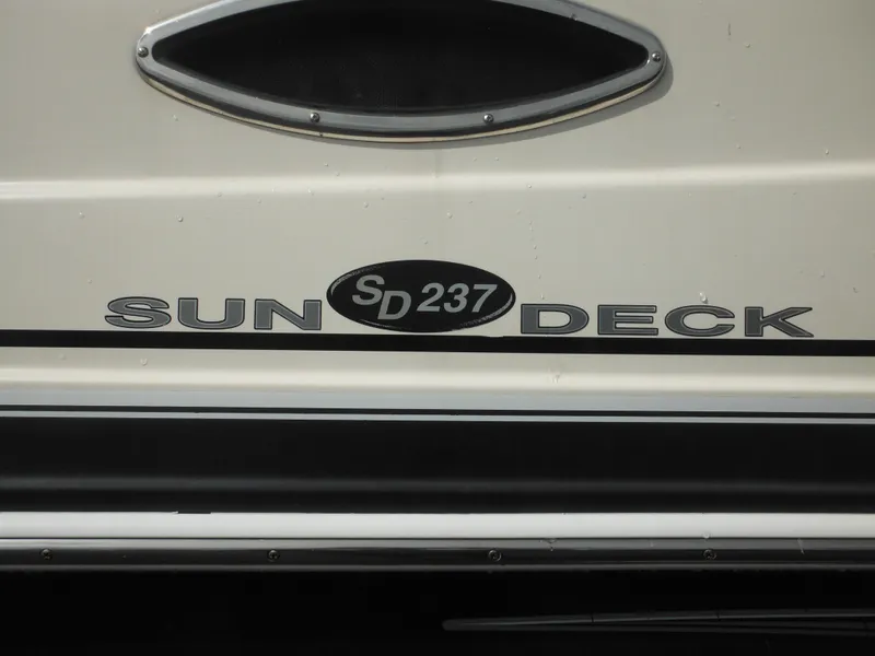 Slide: The Image of 2007 Hurricane SD 237 Sun Deck boat logo on white surface. - 8