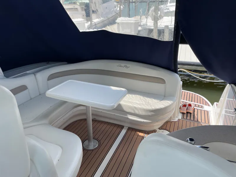 Slide: The Image of 2004 Sea Ray 320 Sundancer interior with seating, table, and teak flooring. - 6