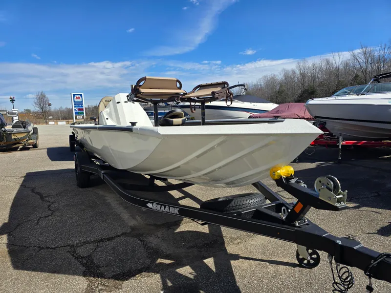 Slide: The Image of 2025 SeaArk Flex 19 boat on trailer under clear blue sky. - 3