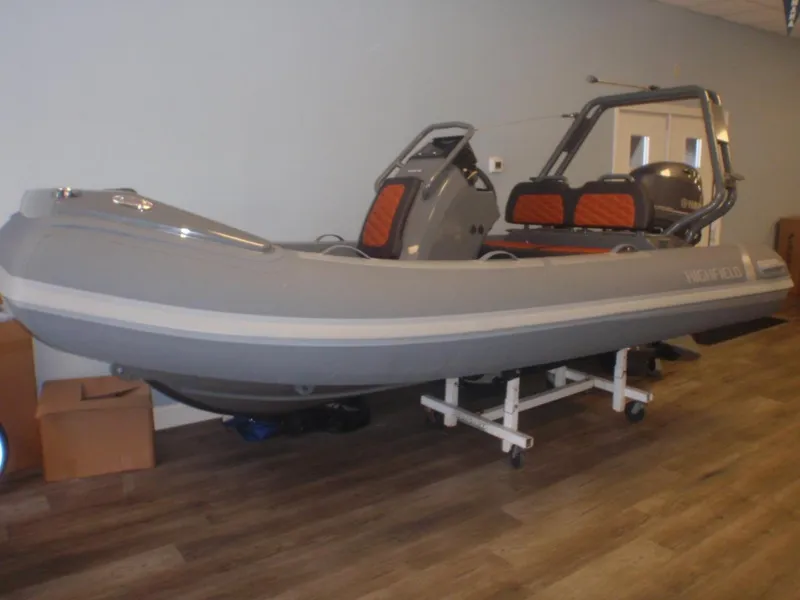 Slide: The Image of 2025 Highfield Sport 390 inflatable boat displayed indoors on a stand. - 1