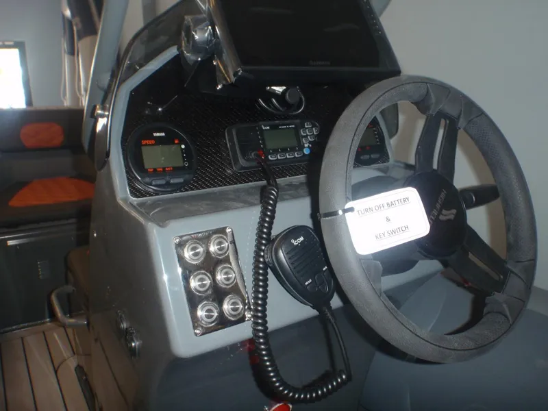Slide: The Image of 2025 Highfield Sport 390 boat dashboard with steering wheel and control panel. - 3