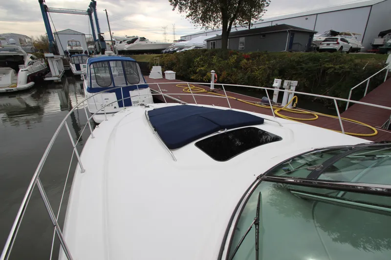 Slide: The Image of 2007 Sea Ray 44 Sundancer yacht docked at marina with covered sunroof. - 12