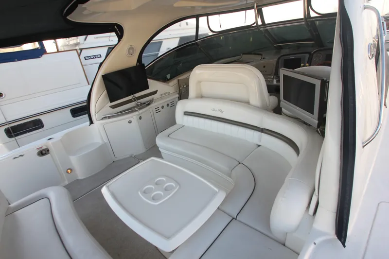 Slide: The Image of 2007 Sea Ray 44 Sundancer yacht interior with white seating and entertainment area. - 20