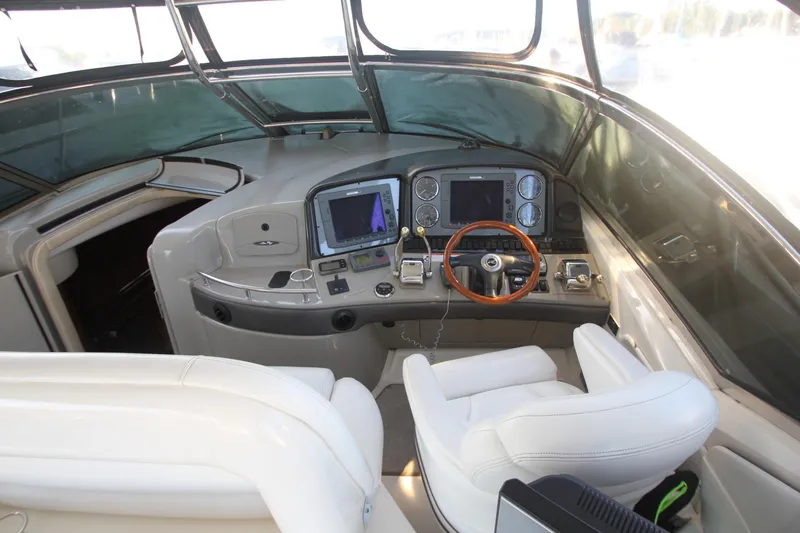 Slide: The Image of 2007 Sea Ray 44 Sundancer helm with modern navigation equipment and luxurious seating. - 22
