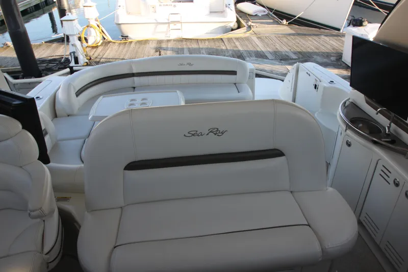 Slide: The Image of 2007 Sea Ray 44 Sundancer yacht interior with white seating and entertainment area. - 24