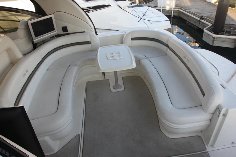 Slide: The Image of Luxurious seating area on a 2007 Sea Ray 44 Sundancer yacht with a central table. - 28