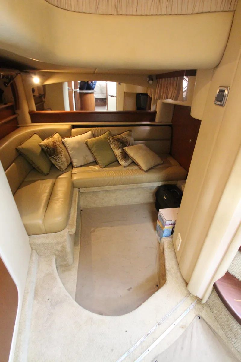 Slide: The Image of 2007 Sea Ray 44 Sundancer interior with beige seating and cushions in cozy cabin space. - 36
