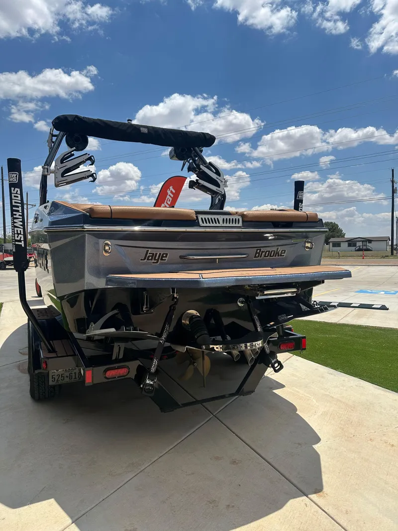 Slide: The Image of 2023 Supreme S220 boat on trailer, sunny day, rear view. - 12