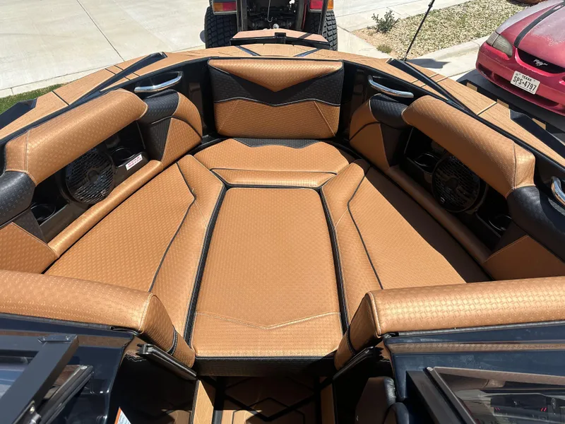 Slide: The Image of 2023 Supreme S220 boat interior with tan leather seating and black accents. - 4