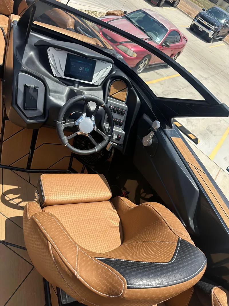 Slide: The Image of 2023 Supreme S220 boat interior with modern dashboard and luxurious seating. - 5