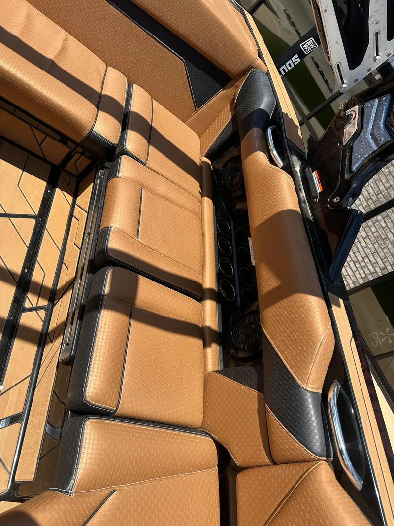 Slide: The Image of Luxurious tan interior of 2023 Supreme S220 boat with sleek design and premium materials. - 7