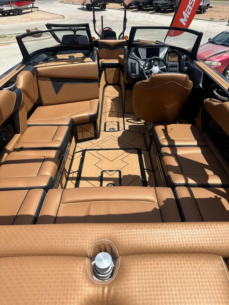 Slide: The Image of 2023 Supreme S220 boat interior with luxurious tan seating and modern dashboard. - 9