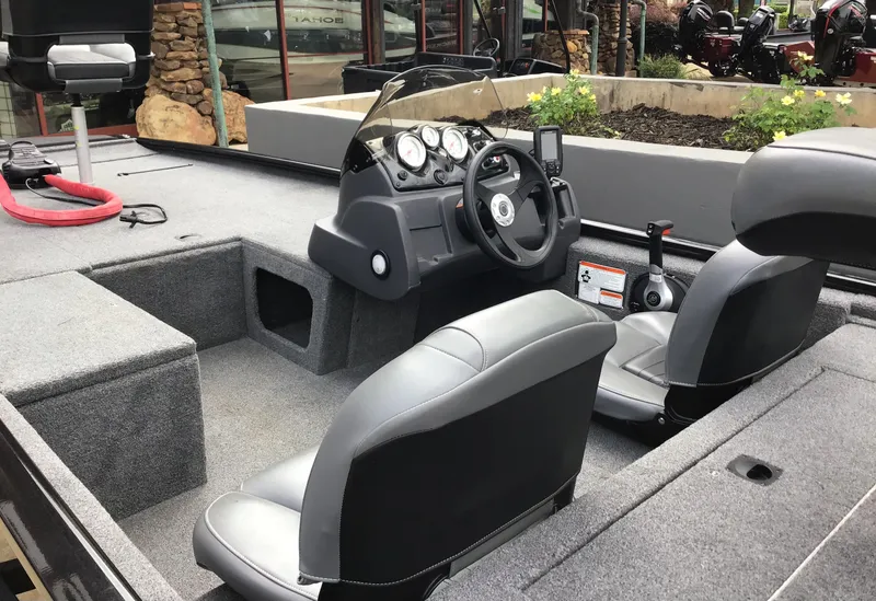 Slide: The Image of 2024 Tracker Pro 170 boat interior with steering console and seating. - 2