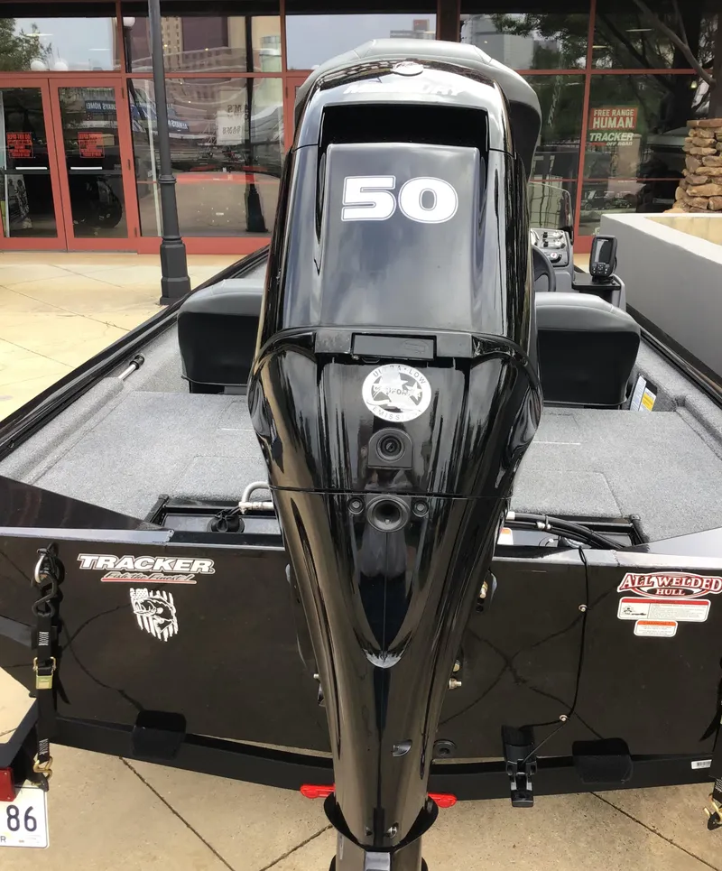 Slide: The Image of 2024 Tracker Pro 170 boat with a 50 HP engine, displayed outdoors. - 3