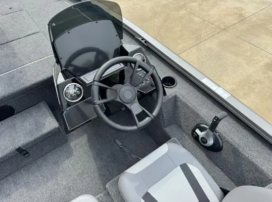 Slide: The Image of 2025 Lowe Stinger ST175 boat cockpit with steering wheel and control panel. - 5