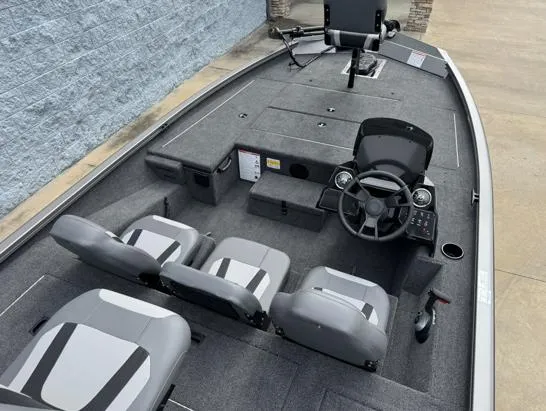 Slide: The Image of 2025 Lowe Stinger ST175 boat interior with gray seating and steering console. - 6