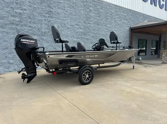 Slide: The Image of 2025 Lowe Stinger ST175 boat with Mercury engine on trailer, parked outside a building. - 8