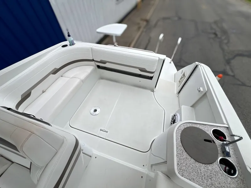 Slide: The Image of 2004 Formula 27 PC boat interior with white seating and cup holders. - 16