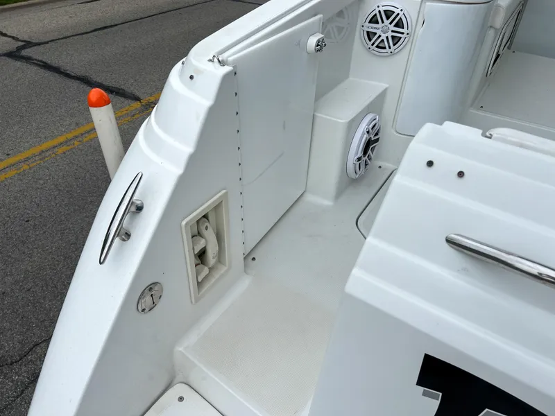 Slide: The Image of 2004 Formula 27 PC boat deck with speakers and cleat, docked on pavement. - 17