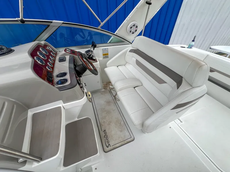 Slide: The Image of 2004 Formula 27 PC boat interior with white seating and control panel. - 18