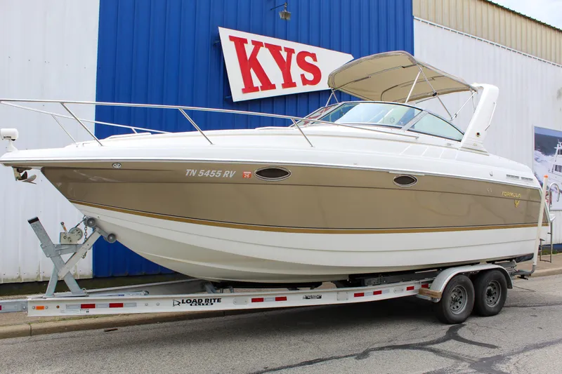 Slide: The Image of 2004 Formula 27 PC boat on trailer, parked outside KYS building. - 2