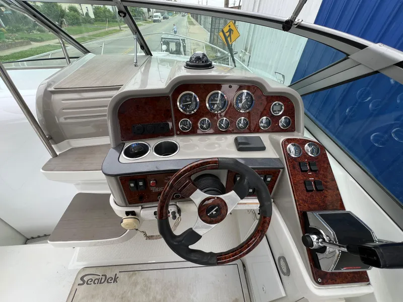 Slide: The Image of 2004 Formula 27 PC boat dashboard with steering wheel and control panel. - 21