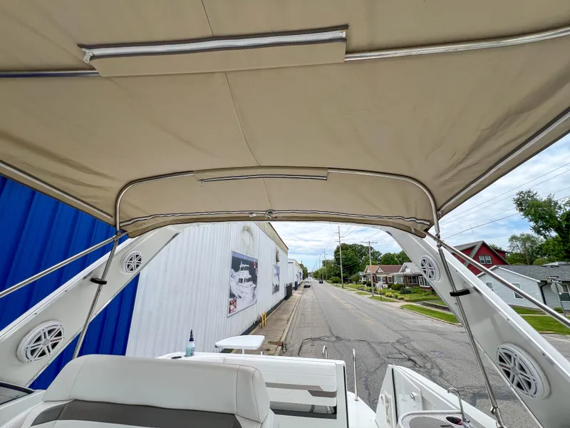 Slide: The Image of 2004 Formula 27 PC boat with beige canopy, parked on a street near buildings. - 23